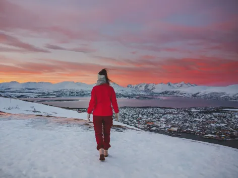 Girl walking in winter sunset with a Tromsø view