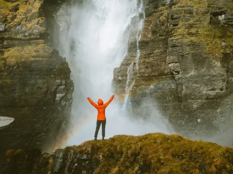 Person standing in front of a waterfall