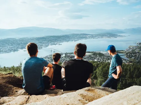 Group of friends enjoying the view of Tromsø from the Sherpa stairs