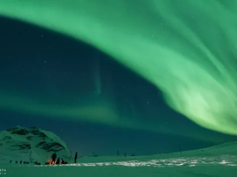 Enjoying the northern lights around a bonfire outside of Tromso