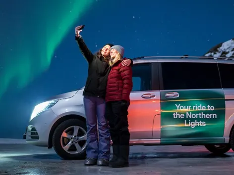 Two people taking a selfie on a northern lights tour with Bolt in the Tromso region