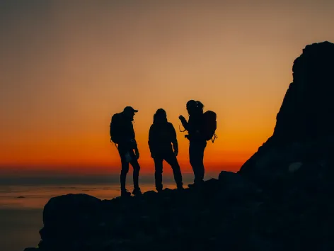 Silhouettes on a mountain top in sunset