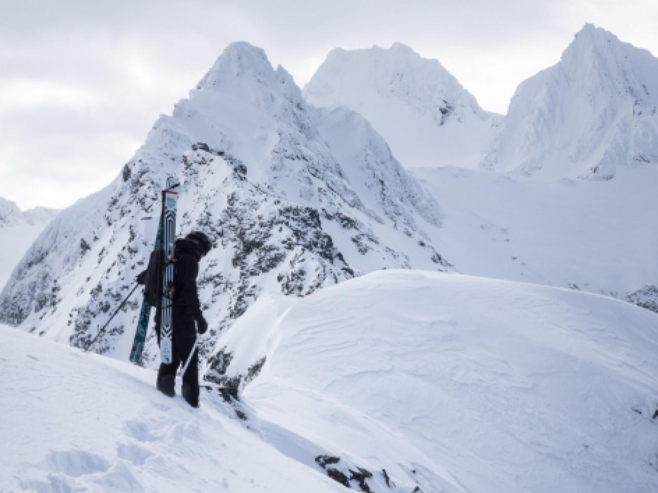 professional skier and filmmaker Nikolai Schirmer skiing down steep mountainsides