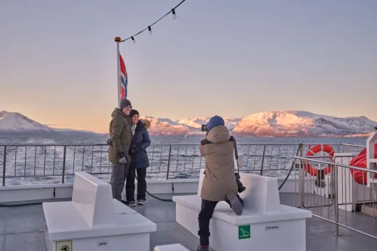 Photographing a couple on the deck of a boat