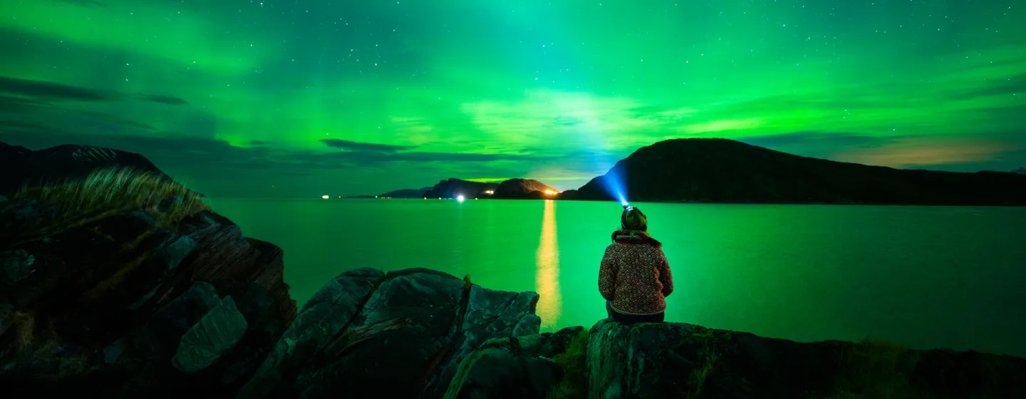 Enjoying the norhtern lights from a beach