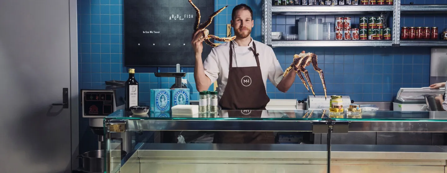 Chef at Mathallen in Tromsø showing some king crab