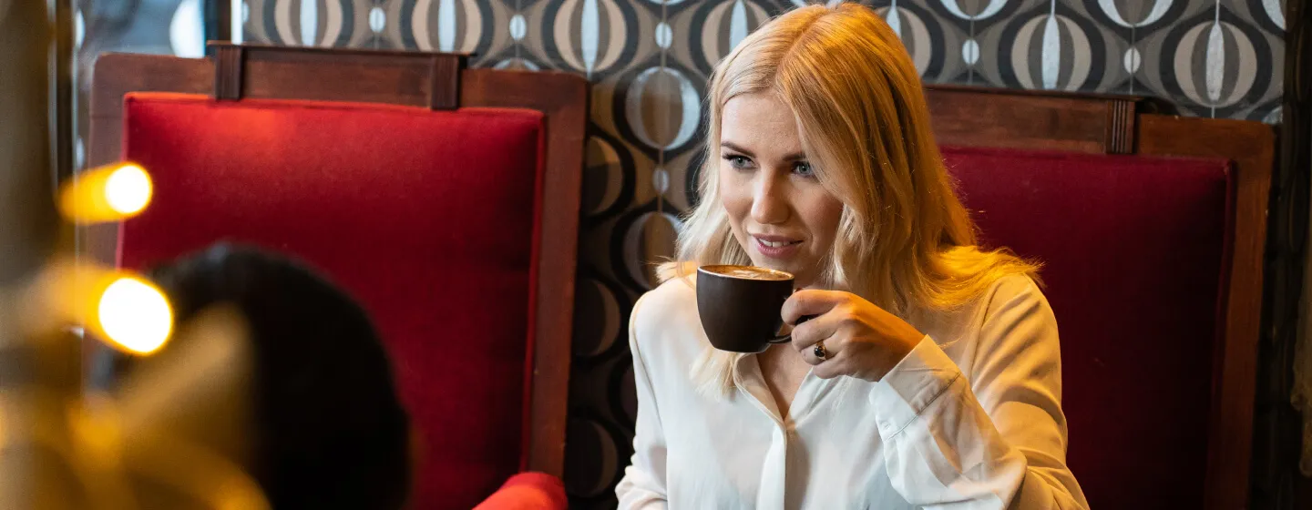 Girl enjoying a coffee at a café in Tromsø