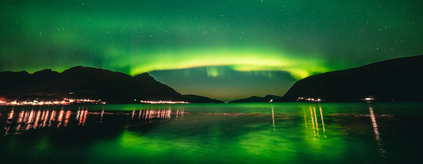 Northern lights above a fjord