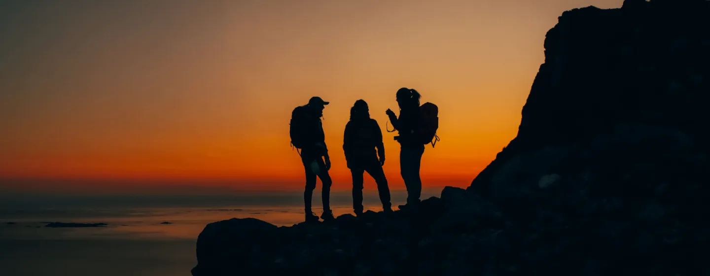 Silhouettes on a mountain top in sunset