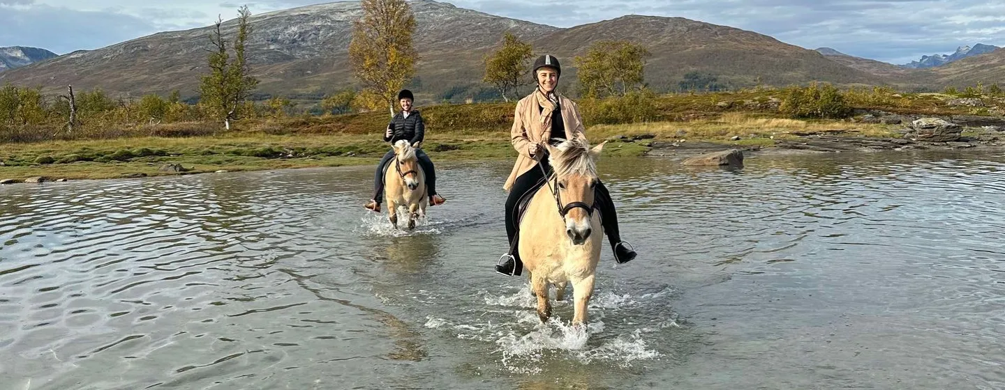 Two people riding horses