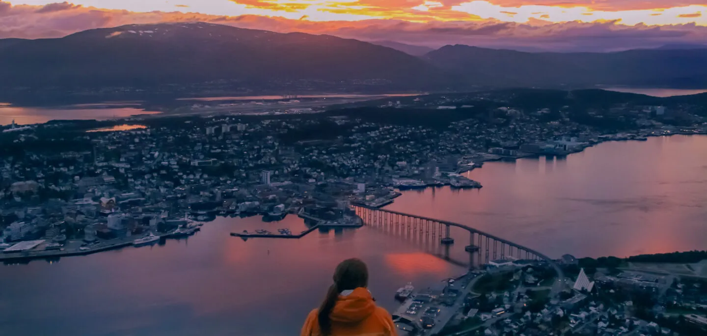 Woman at the top of the cable car looking at the evening view of Tromso