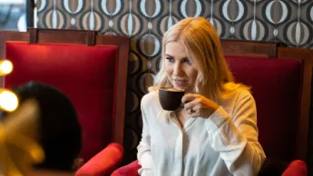 Girl enjoying a coffee at a café in Tromsø